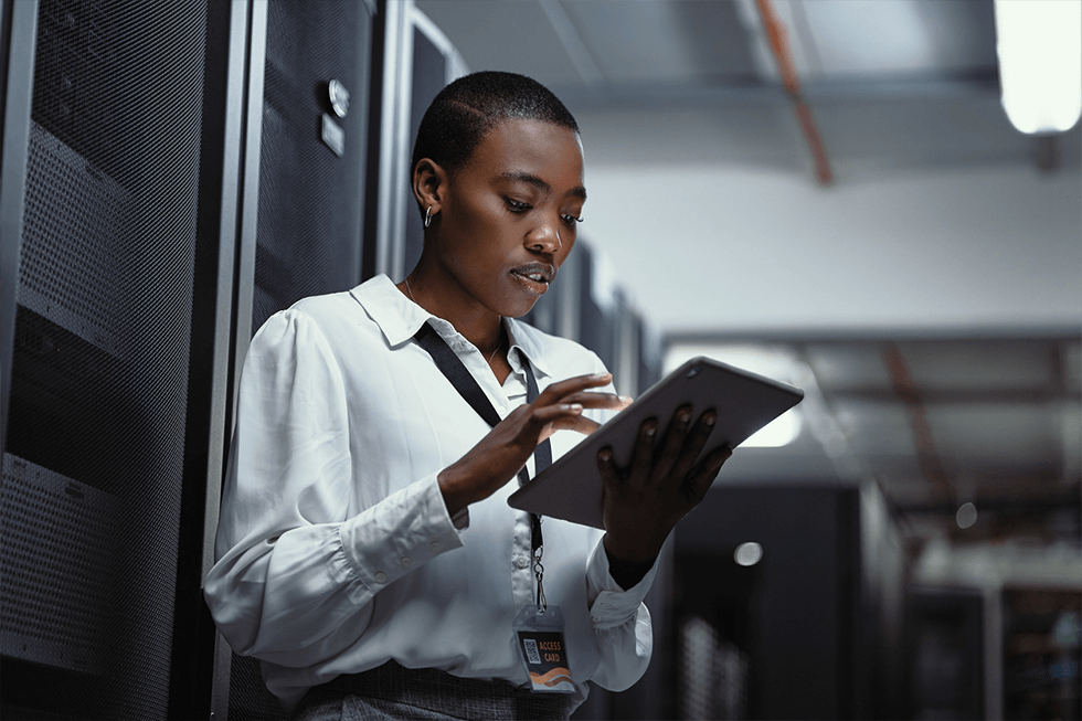 Female IT technician using a digital tablet in a server room