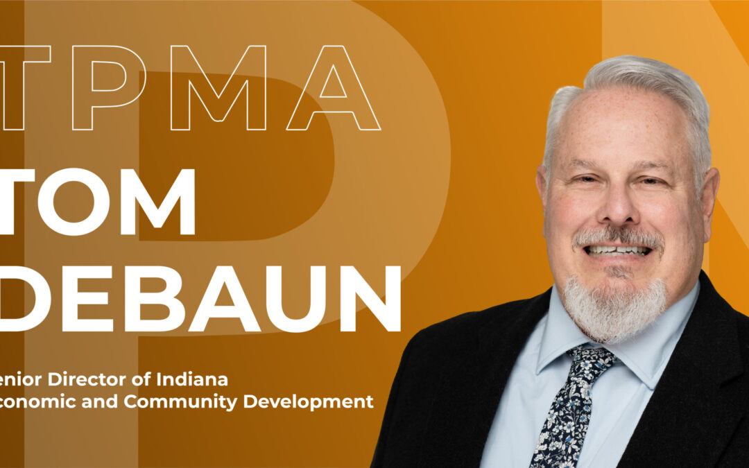 A photo of Tom Debaun wearing a suit in front of an orange background. To the left of tom reads "TPMA Tom Debaun Senior Director of Indiana Economic and Community Development"