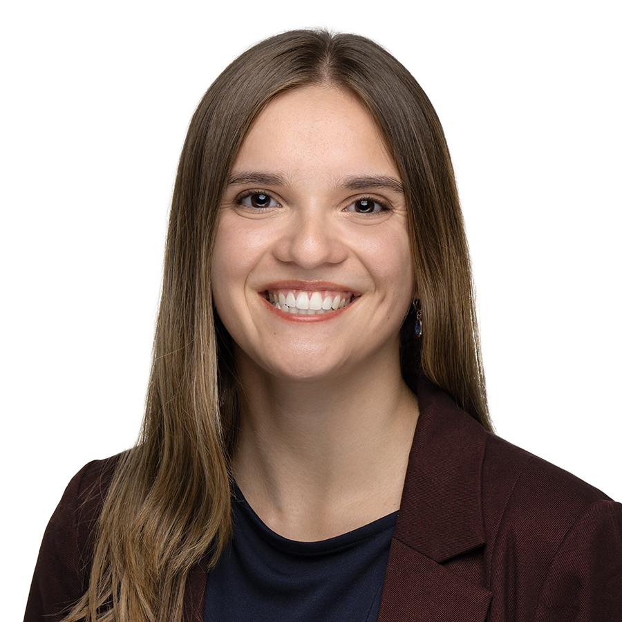 Headshot of Allison Digilio who is a Business Development Coordinator from Pennsylvania. She has reddish-brown hair, glasses and is wearing a green button up.